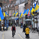 National flags of Ukraine are seen hanging above shops following Russia's invasion of Ukraine, in London